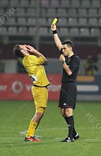 Referee shows the yellow card
