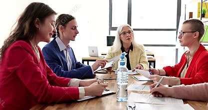 Manager and employees think of new ideas at business meeting