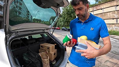 A man delivering takeaway food and beverages