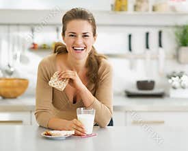 Smiling young woman having healthy breakfast