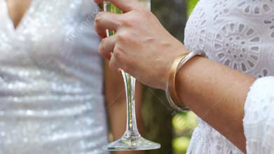women in white dresses with glasses of champagne. Bachelorette party.