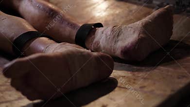 Creepy bandaged legs with the scars of a plastic mannequin in a quest room.