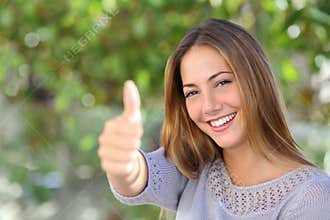 Beautiful woman agreement with thumb up outdoor