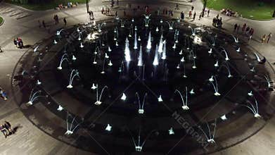 Look down aerial on fountain in night illumination