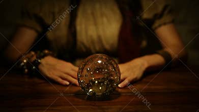 Fortune teller looks in the future and lifts thumb up