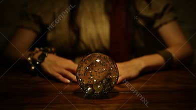 Fortune teller looks in the future and lifts thumb down