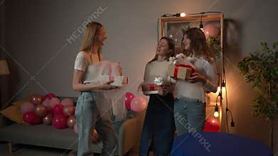 Group of young women friends celebrating bachelorette party at home, waiting for bride, chatting talking smiling