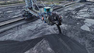 Flying over industrial port and warehouse for fossil fuels, coal and ore in the open air.