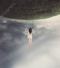 Surreal swing with woman
