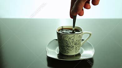 Stir with a spoon, coffee in a cup