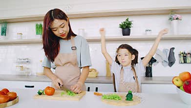 Culinary Bonding A Joyful Experience Between Mother and Child Cooking Together in a Brightly Lit Kitchen Filled with