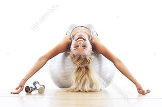 Woman lying on fitness ball