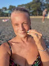 woman in a swimsuit on the background of a pebble beach in Kobuleti, Georgia