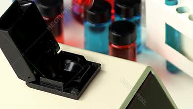 Removing test tube of red liquid