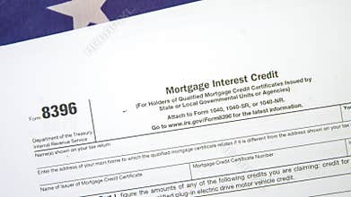 Close-Up of IRS Form 8396 for Mortgage Interest Credit with American Flag Background Highlighting U.S. Tax Filing