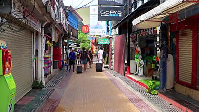 Walking with coffee in the hand through tourist street Thailand