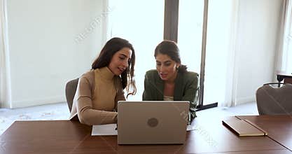Latina businesswomen met in office develop marketing strategy using laptop