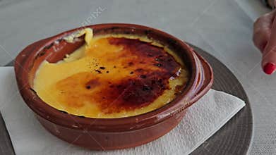 Spoon plunged into Catalan cream, close up