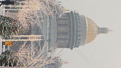 Russia, St Petersburg, 30 December 2023: people walk among Christmas trees in heavy snowfall, a park organized on