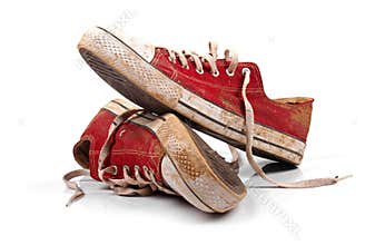 A pair of dirty sneakers isolated on white