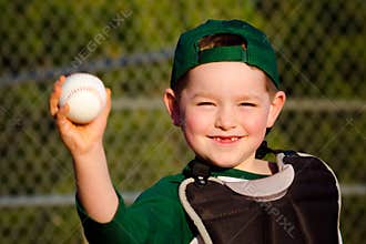 Young child in catcher's gear throwing