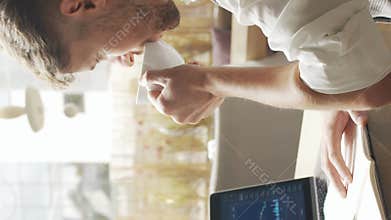 Businessman sitting and working in a cafe. Man using computer and devices. Business and entrepreneurship concept