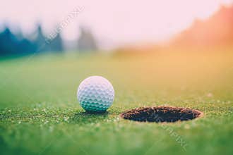 Golf ball lies close to hole promising chance for victorious putt closeup. Golf course under relaxing sunlight for