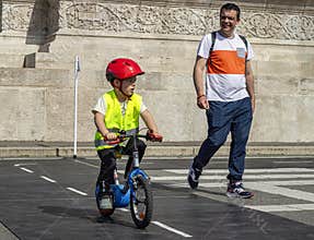 An eight-year-old Hungarian boy rides a bike on Bike Day in the KRESZ park on May 11 in H?sök square in Budapest.