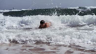 Two boys dive into a foaming wave. Live a healthy life. Be H3althy