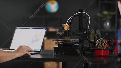 A graphic designer uses a laptop and makes a sketch of postoperative fixation bandage in red colour for the heart and