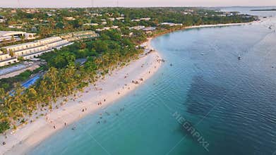 Aerial view of beautiful bungalow and sea at sunset in summer