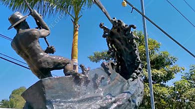 Statue sculpture angler with fish fountain in Puerto Escondido Mexico