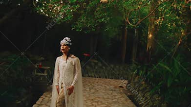 Elegant bride in a vintage dress posing in a lush garden