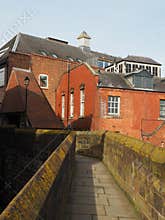 view along the historic city walls in Chester with town centre buildings near eastgate