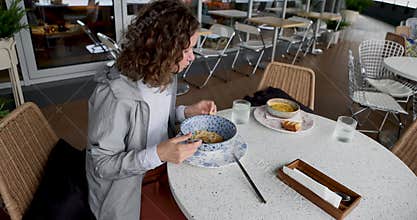 Dining Experience Woman Is Radiantly Enjoying Meal on Beautiful and Scenic Outdoor Terrace Setting