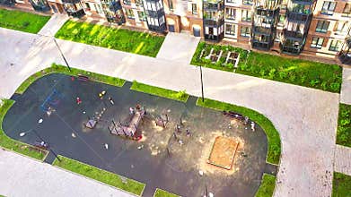 Areal footage of the children playing on the playground in the modern district, City