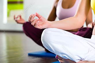 Women in the gym doing yoga exercise for fitness