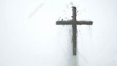 Ashes cross appears on white surface in quiet winter setting