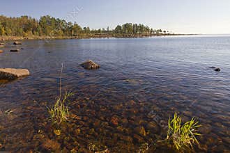 A rocky water inlet and rocky coastline in the soft morning light