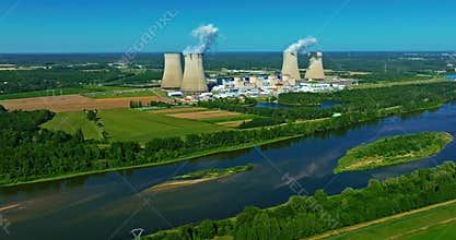 Aerial view of nuclear power plant along a river at summertime