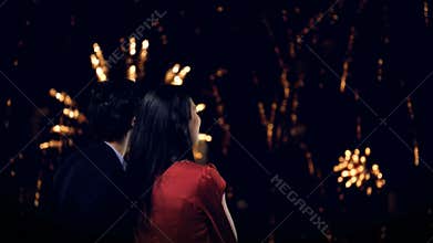 Young couple looking at fireworks