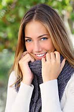 Beautiful woman with a white perfect smile in winter