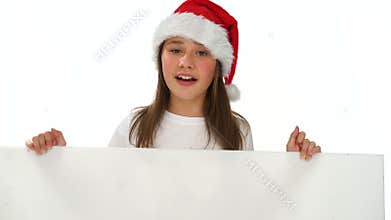 Young girl in a Christmas hat with a blank sign