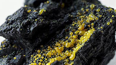 Close-up of yellow particles on black ore, Generative AI