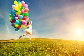 Happy birthday woman against the sky with rainbow-colored air ba