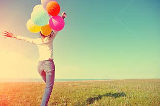 Young asian woman with colored balloons
