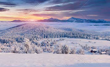 Panorama of the foggy winter sunrise in mountain village