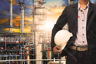 Engineering man with white safety helmet standing in front of oi