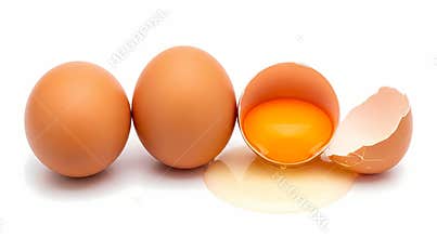 Three brown eggs with one cracked open showing the yolk