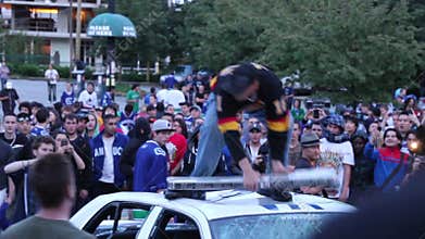 Rioter kicks and destroy police car light-bar